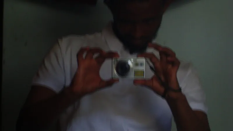 NatiFlux taking a mirror photo with a compact camera