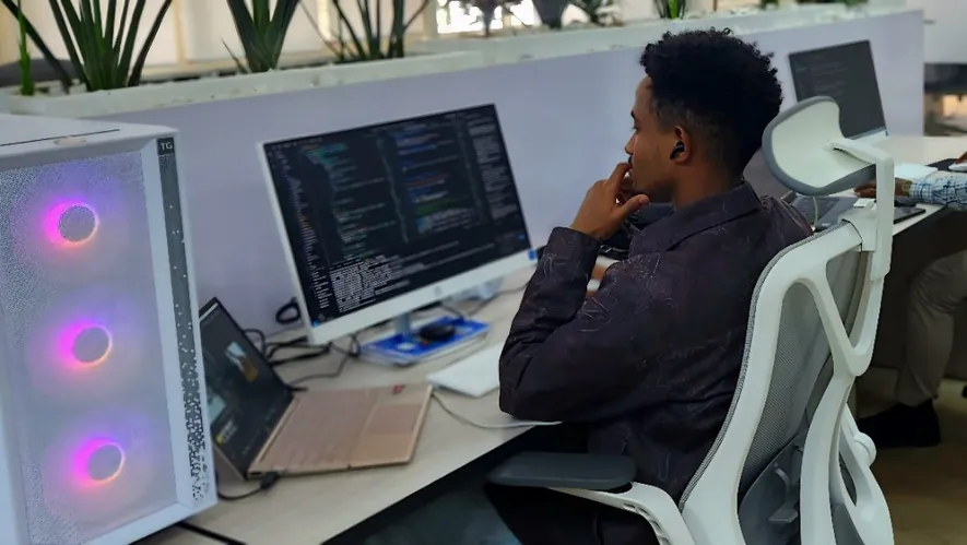 NatiFlux coding at a Vtech workspace with dual monitors